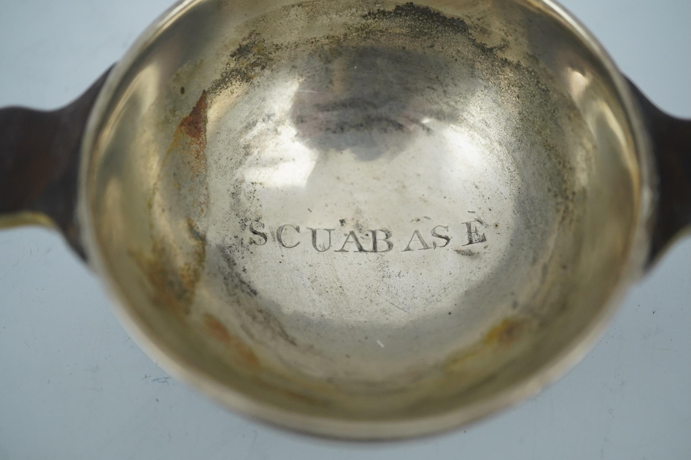 An early 19th century silver mounted yew wood quaich, inscribed 'Scuab As E' to the bowl and 'To Charles Gibson / From A Butter of Faskally' around the rim, dated 1830 beneath one handle, 10.6cm over handles. Condition -